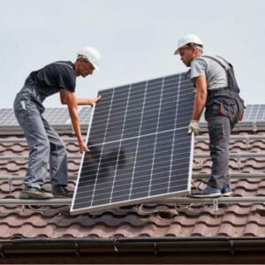 workers installing new solar panels to roof of a home