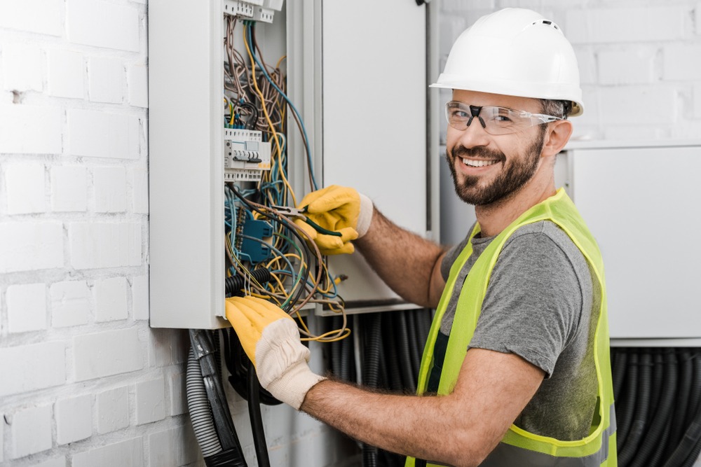 Electrician working on electrical panel circuit breaker box (1)