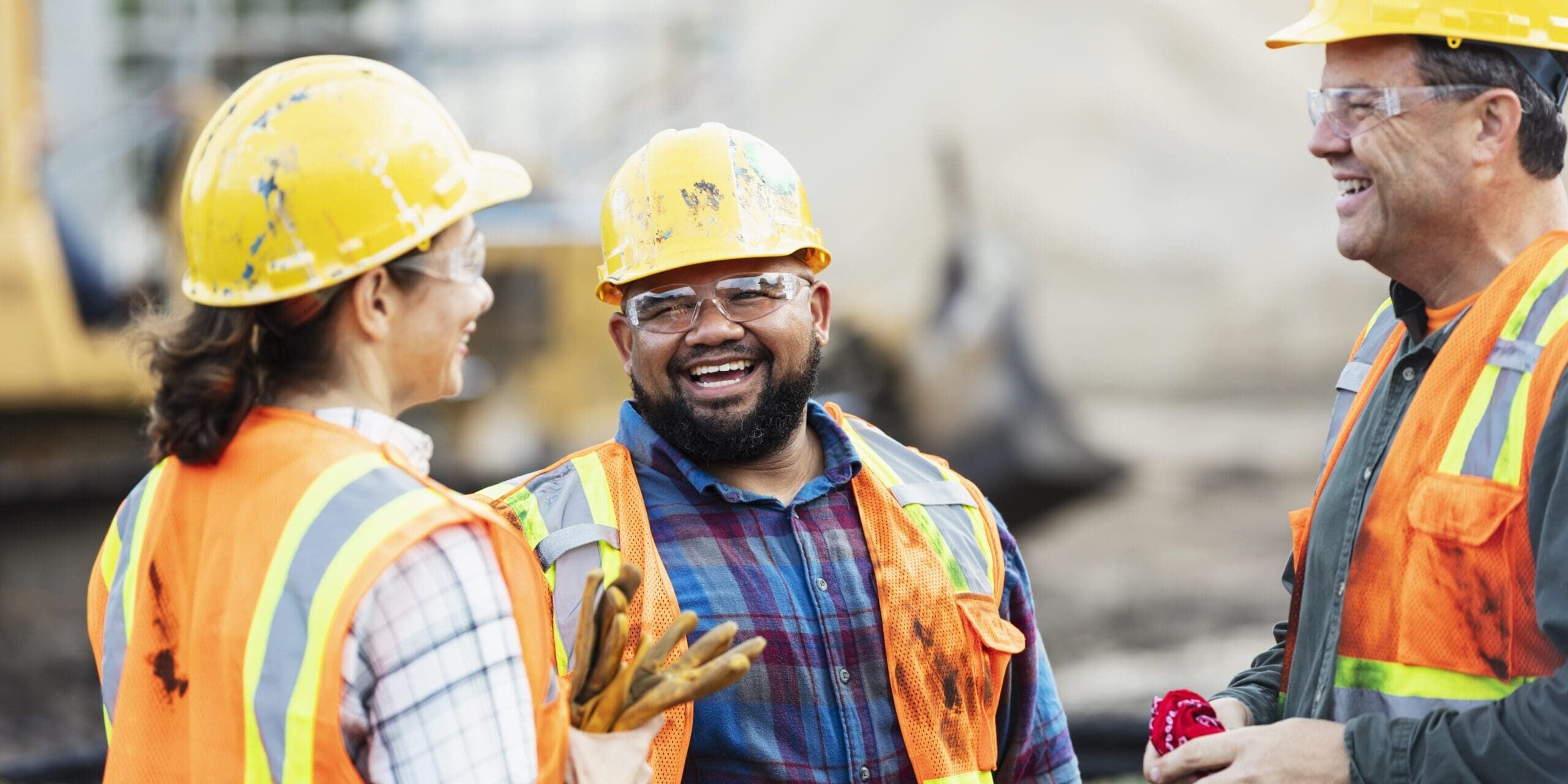 Three multi ethnic construction workers chatting